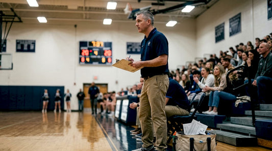 Basketball coach charting stats during live game