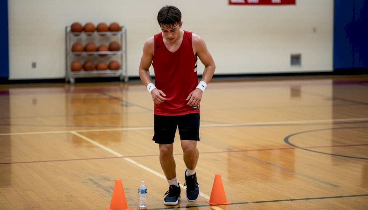 Basketball player mid-drill in school gym