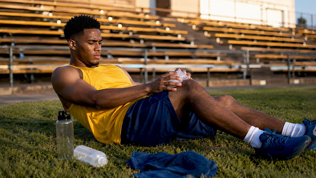 Basketball player applying ice pack post-game